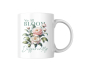 Preview: Weiße Keramiktasse mit botanischem Design und dem Zitat „We All Bloom Differently“, freigestellt auf weißem Hintergrund.